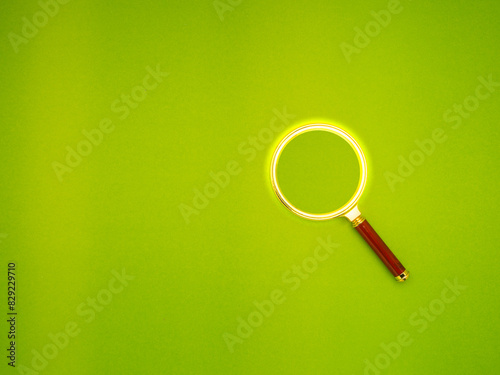 Magnifying glass on a green background.
