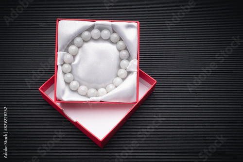 Jade bangle or bracelet in a red box on a black background.