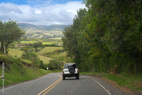 White car on a two lane road in the Colombian countryside © EGT