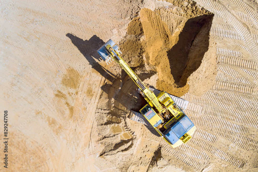 An excavator during earthworks at prepares trench for sewer pipes An excavator during earthworks at prepares trench for sewer pipes