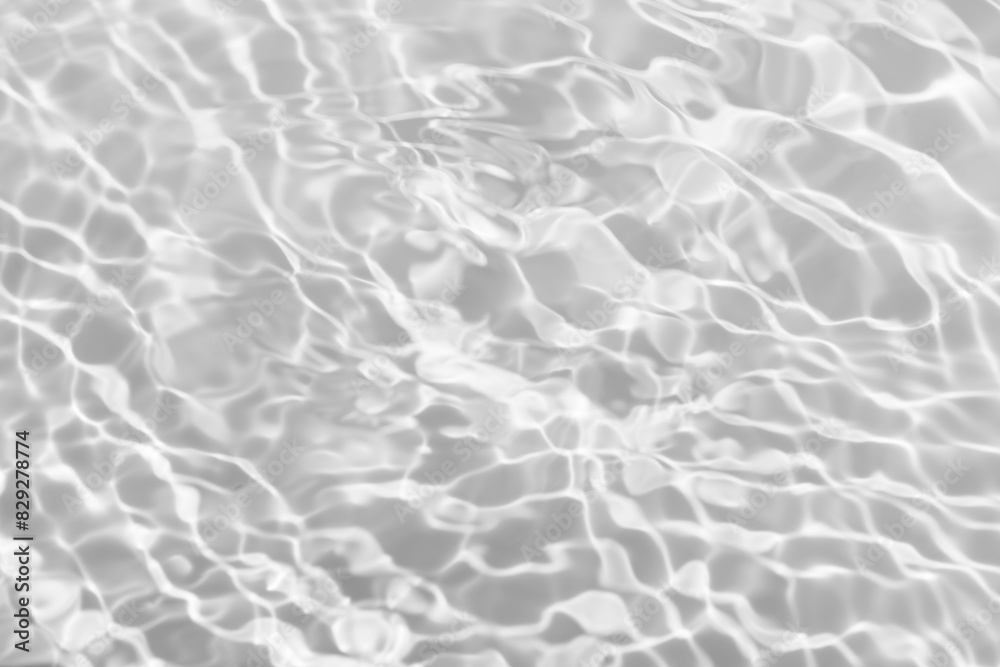 Obraz premium White water with ripples on the surface. Defocus blurred transparent white colored clear calm water surface texture with splashes and bubbles. Water waves with shining pattern texture background.