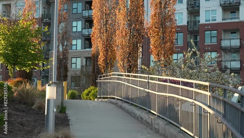 Apartment complex with landscaped garden and walkway at sunset