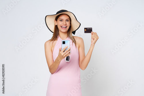 Happy asian woman using credit card and smartphone app, paying on website via mobile phone, white background.