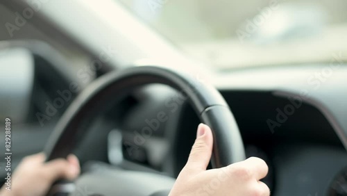 Wallpaper Mural Close-up of hands gripping the steering wheel while driving a car. The focus is on the driver's hands, showcasing concentration and control on the road. Torontodigital.ca