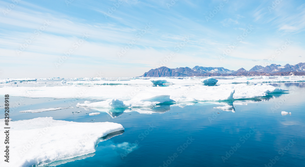 Melting icebergs by the coast of Greenland, on a beautiful summer day - Melting of a iceberg and pouring water into the sea - Greenland Melting icebergs by the coast of Greenland, on a beautiful summer day - Melting of a iceberg and pouring water into the sea - Greenland