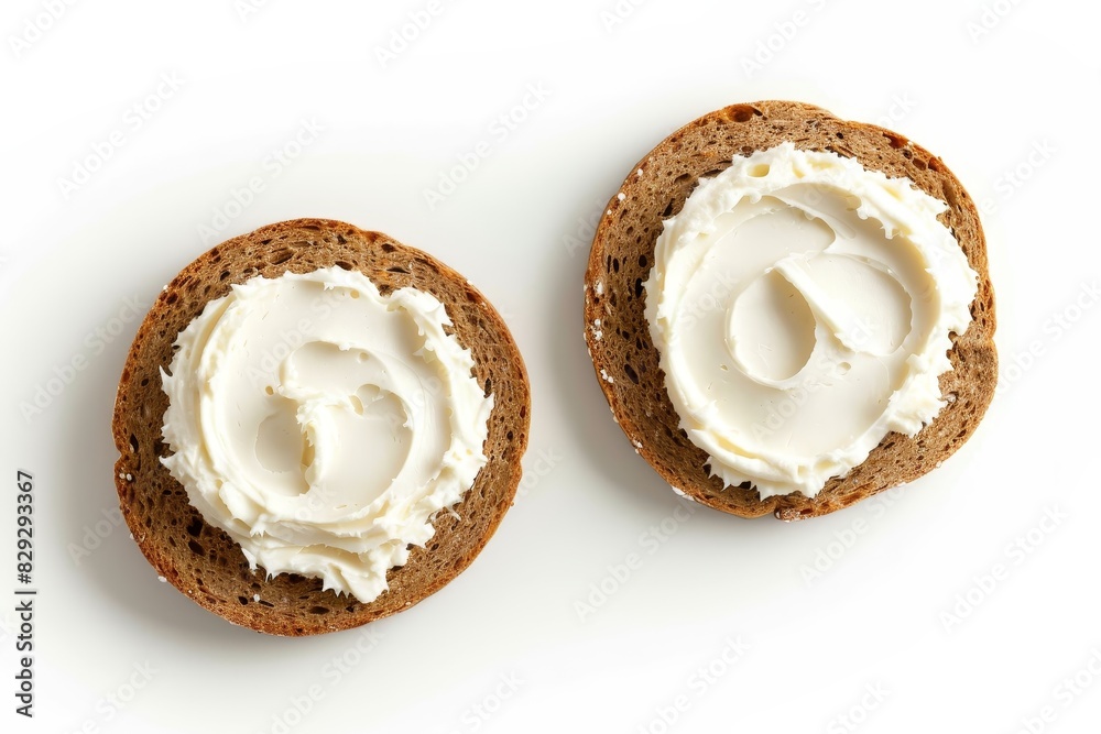 Two round rye crisps topped with cream cheese on white background Two round rye crisps topped with cream cheese on white background