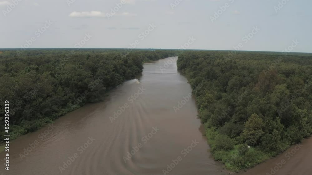Aerial Panning Shot Of Nautical Vessel Moving On Rippled River Stream Amidst Green Trees In Jungle - Bayou Vista, Texas Aerial Panning Shot Of Nautical Vessel Moving On Rippled River Stream Amidst Green Trees In Jungle - Bayou Vista, Texas