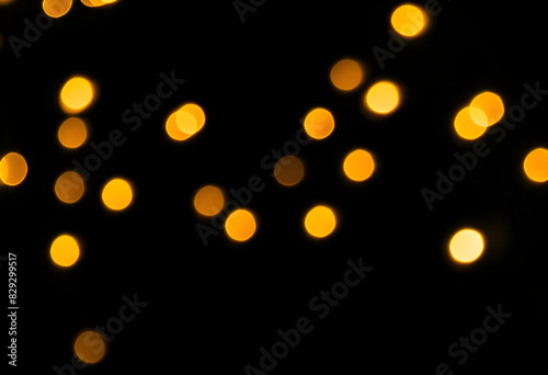 A close-up of snowflakes with a blurred, bokeh effect on a black background