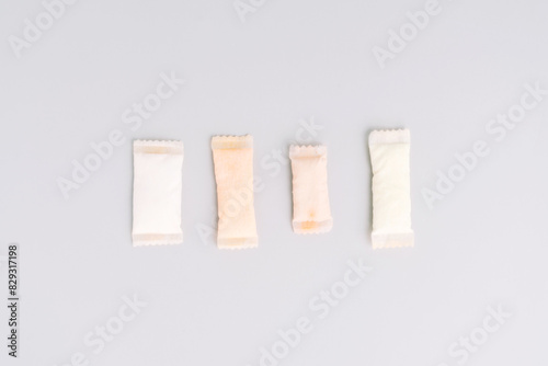 Assorted sachets of non-smoking tobacco product with different flavors on a light background.