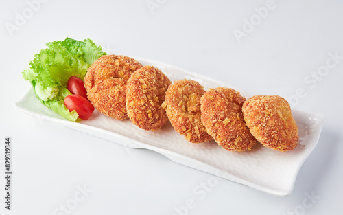 Shrimp Donut (Shrimp coated in flour and bread crumbs fried in oil) served on white plate isolated on white background.