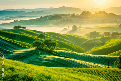 Serene and picturesque landscape with valleys and the sun casting a warm glow over the fields.
