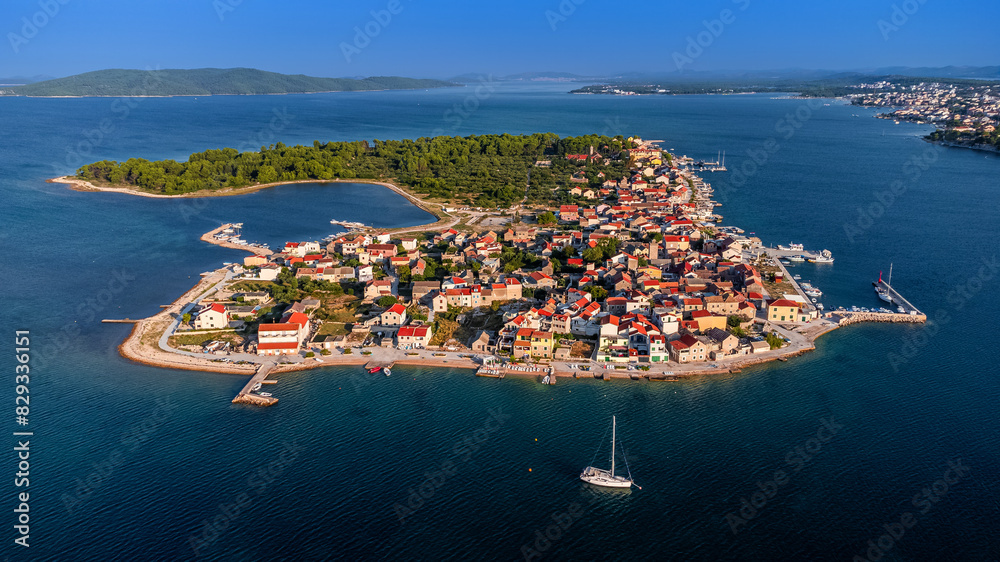 Krapanj, Croatia - Aerial view of Krapanj island (Otok Krapanj), the smallest inhabited island in Croatia. Yachts, red rooftops and clear blue sky on a sunny summer morning by the Adriatic sea