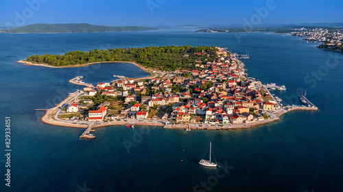 Krapanj, Croatia - Aerial view of Krapanj island (Otok Krapanj), the smallest inhabited island in Croatia. Yachts, red rooftops and clear blue sky on a sunny summer morning by the Adriatic sea