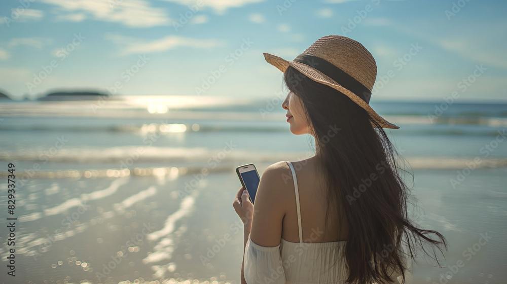 a photograph of an asian womanin her 25s , long black hair, asian, shot from the back, holding an smart phone, walking alone in sunny beach