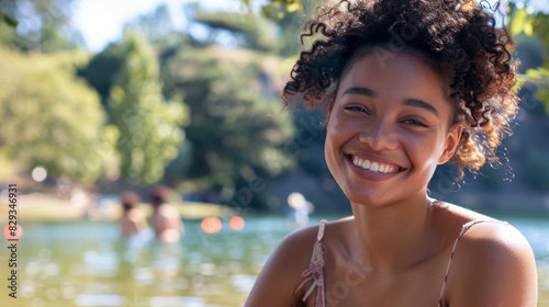 Portrait of a content woman in her 30s in middle of nature near a lake