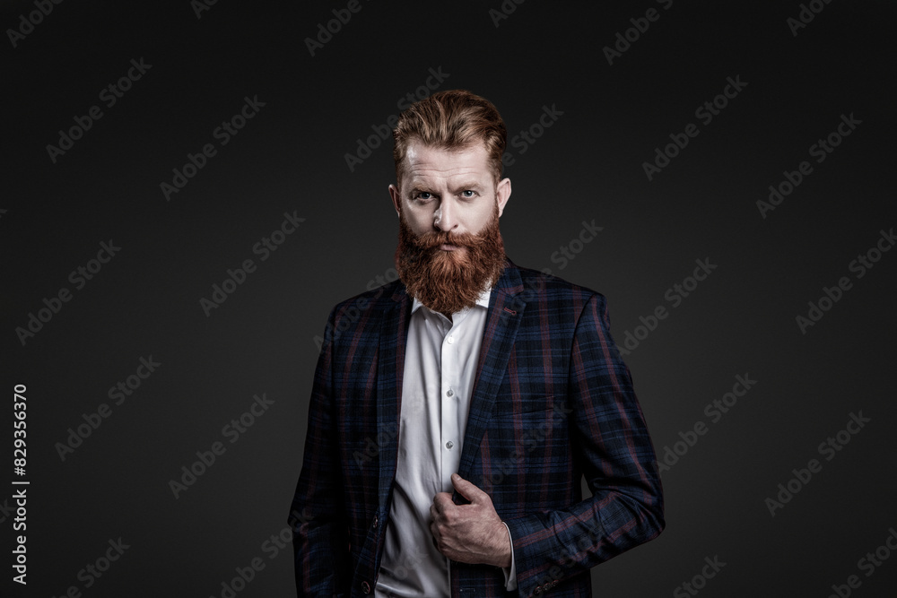 Fototapeta premium Charismatic bearded man in tailored elegant suit jacket formal style with beard isolated on grey