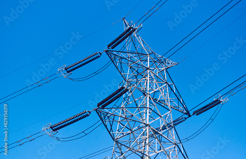 Low angle view of electricity transmission tower with overhead wires in Baghmundi, Purulia, West Bengal. Part of electricity grid, it carries high voltage electricity through long distance rural areas