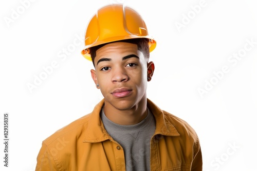 Young male construction worker in safety helmet viewing city buildings under construction
