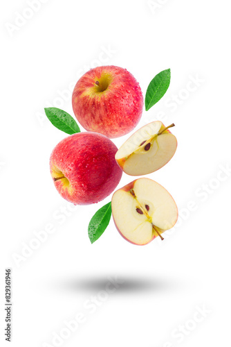 Flying group red apple with slices and green leaf isolated on white background.