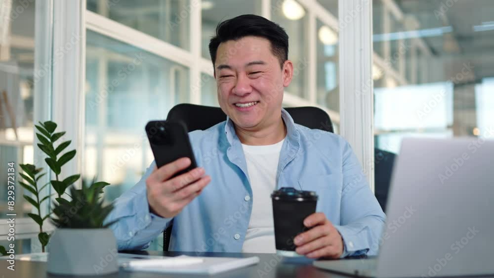 Careless middle age person scrolling social media on personal gadget while having coffee break at workplace. Relaxed programmer distracting from project development and having fun in cyberspace. Careless middle age person scrolling social media on personal gadget while having coffee break at workplace. Relaxed programmer distracting from project development and having fun in cyberspace.