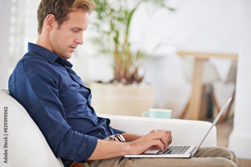 Home, typing and man with laptop on sofa for remote work, communication and reading online news. Living room, internet and person with technology in morning for freelance job, website and planning
