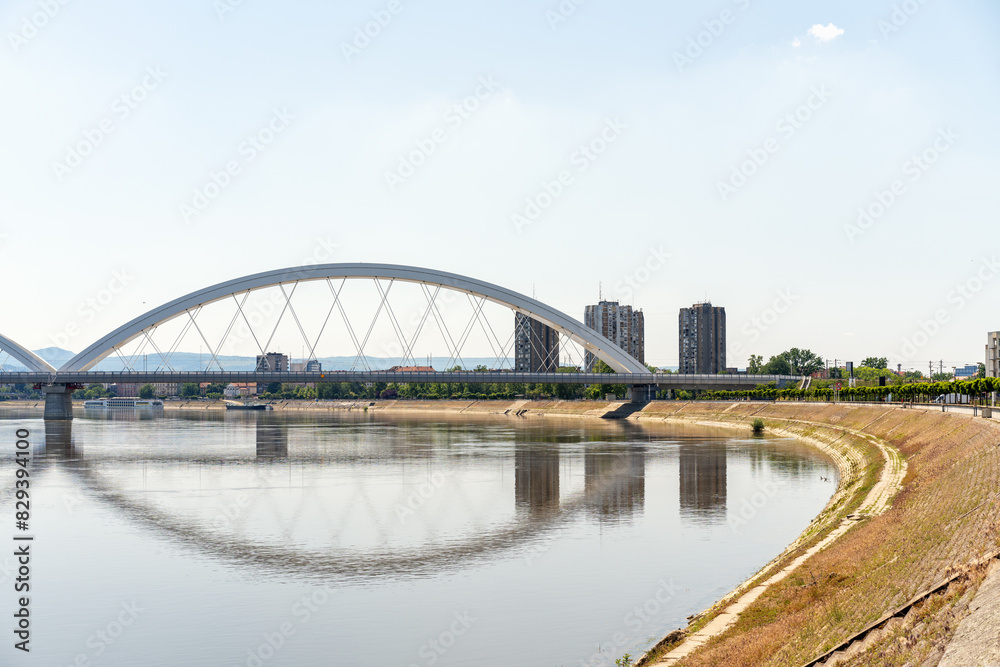 Modern bridge above Danube in front of city. Žeželj Bridge. Landscape of Novi Sad city in Serbia. Modern bridge above Danube in front of city. Žeželj Bridge. Landscape of Novi Sad city in Serbia.
