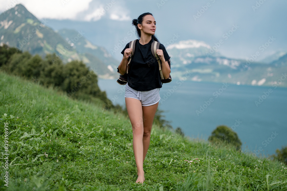 Obraz premium Girl in mountains. Woman hikers trekking in mountains. Young woman walking with backpacks in Alps lake. Woman with big backpack at mountains and blue lake. Travel and tourism. The Hiking.