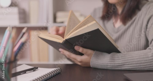 In a close-up shot, a student's hand writes diligently on paper, immersed in the process of learning and completing their homework for an education assignment. closeup write, student photo
