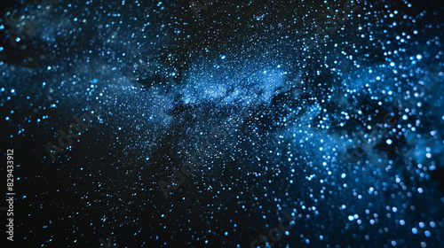 A dark background with tiny blue and white dots forming a starry sky.