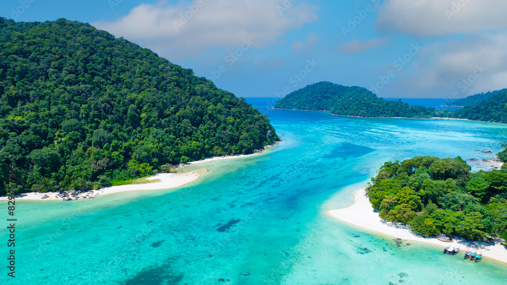 The aerial view of white sand beach tropical with seashore as the island in a coral reef ,blue and turquoise sea Amazing nature landscape with blue lagoon