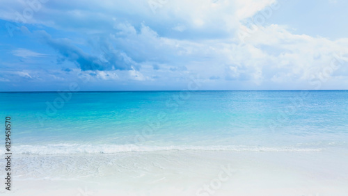 Ocean Tropical Beach with the soft wave water of the sea on the sandy beach background