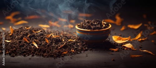 A black tea leaves copy space image with dry tea leaves and dry orange zest photo