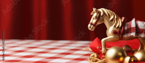 Christmas decoration rocking horse figurine on red white checkerd cloth. copy space available photo