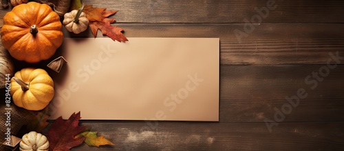 Autumn composition with paper blank and dried leaves with pumpkin on table Flat lay top view copy space