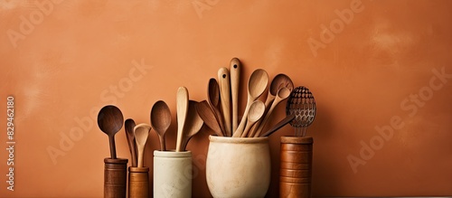 some kitchen utensils like wooden spoon and clay jug beberapa peralatan dapur seperti sendok kayu dan kendi tanah liat. copy space available photo