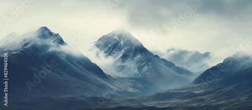 Dramatic skies and high peaks create a vast mountain scene with an incredible copy space image