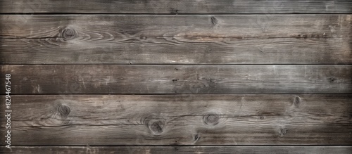 An abandoned and grungy gray wood texture background with dry cracked and aged wood planks providing a copy space image