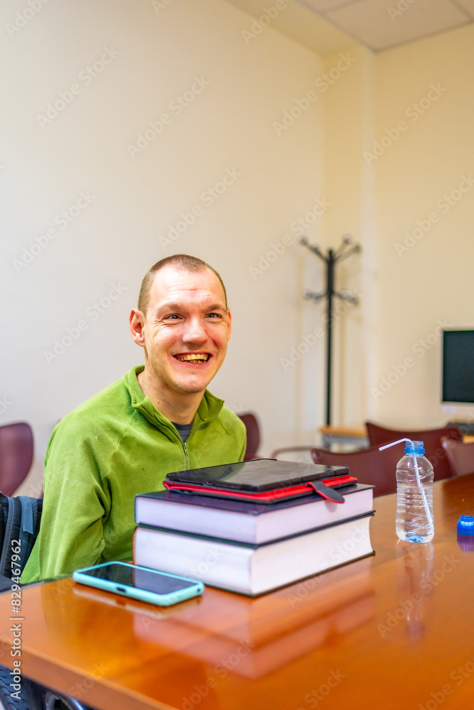 Technology helping a man with disability studying in the university Technology helping a man with disability studying in the university