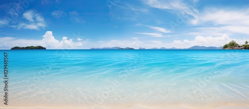 A breathtaking beach with clear water reflecting the surrounding islands is captured in this mesmerizing copy space image