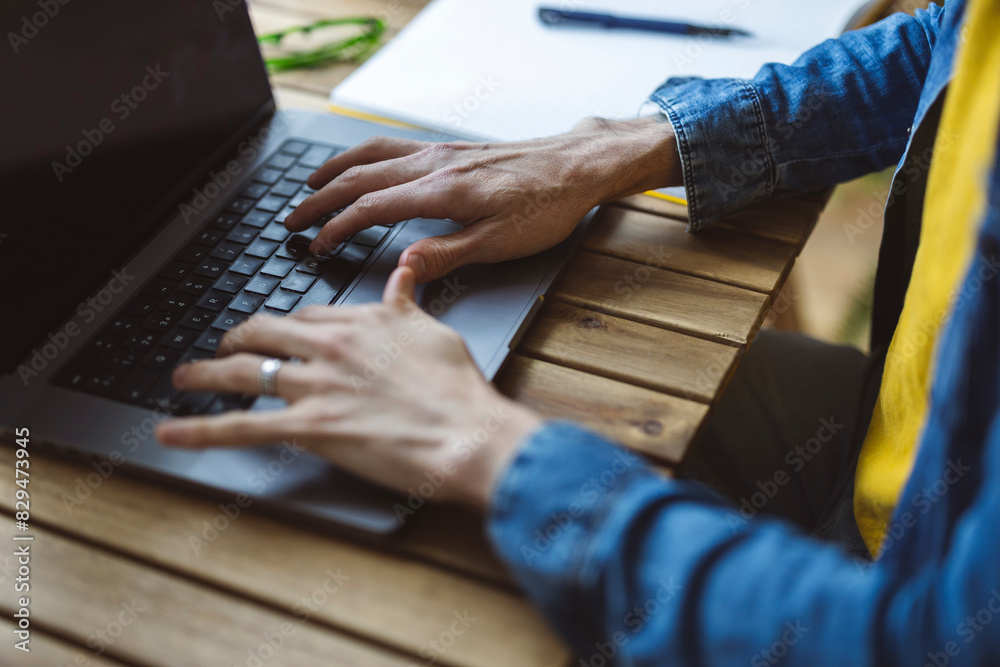 Freelancer typing on laptop at desk Freelancer typing on laptop at desk