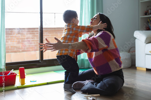 Mother and son hugging each other at home photo