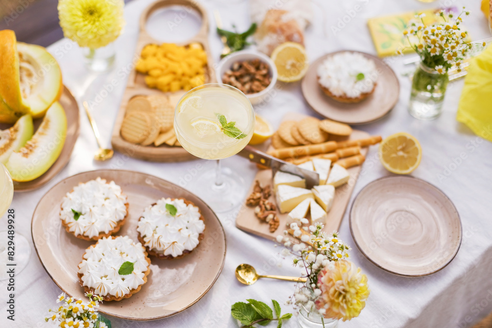 Various food and drink with flowers decorated on table Various food and drink with flowers decorated on table