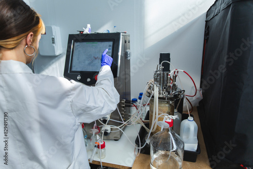 Scientist operating bioreactor making alternative fungal protein in laboratory