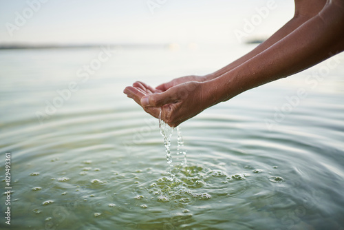 Mature woman holding water in cupped hands photo