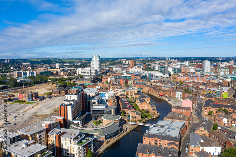 Obraz premium Aerial photo of the Leeds City Centre taken from the area known as The Leeds Dock on a bright sunny summers day showing apartments on either side of the Leeds and Liverpool canal