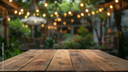 An empty tabletop set in a charming restaurant or home backyard garden  adorned with strings of light bulbs. The scene offers a blank copy space for text  perfect for various creative uses.