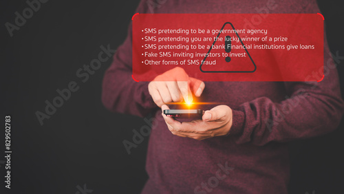 Adult man holding a mobile phone and viewing messages on mobile phone. Fake Text message SMS scam or phishing concept.