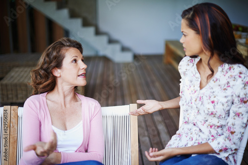 Fight, talking and women in home with argument for problem, angry conversation and communication fail. Conflict, frustrated girl and mother in law speaking in lounge for marriage crisis and divorce