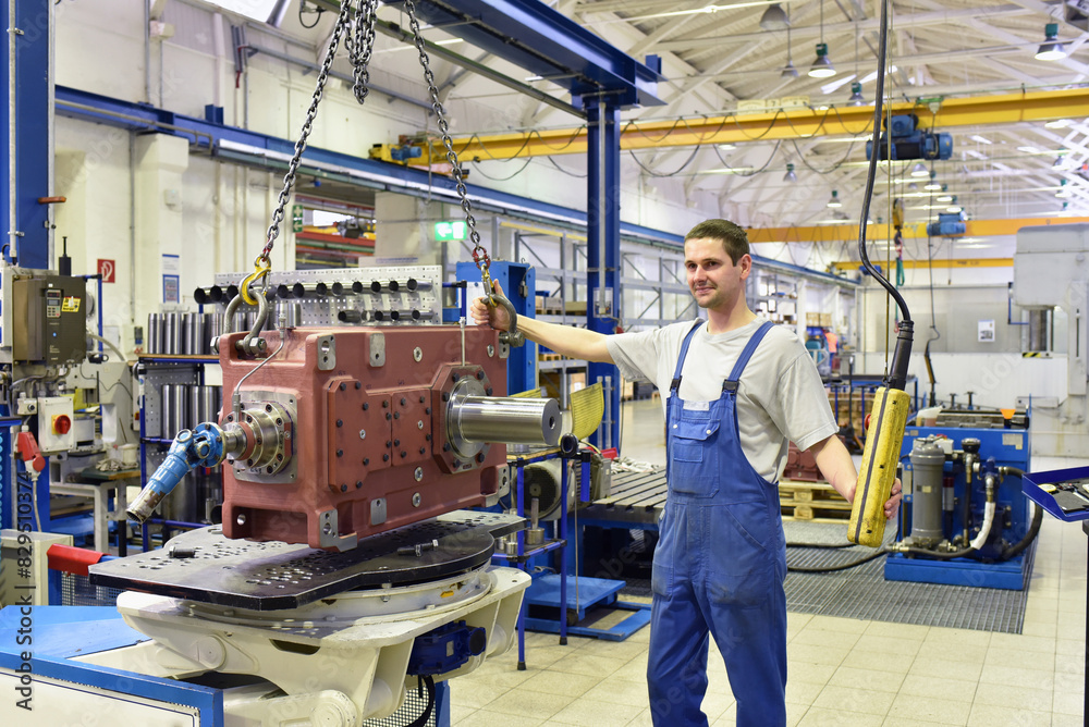 modern mechanical engineering - gear manufacturing factory - assembly by young workers modern mechanical engineering - gear manufacturing factory - assembly by young workers
