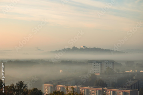 Sonnenaufgang über Marzahn mit tiefen Wolken um den Wolkenhain. photo